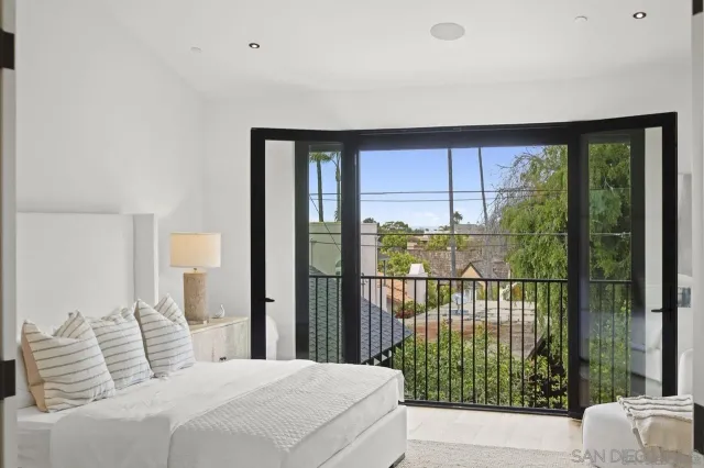 a bedroom with a large window and a bed