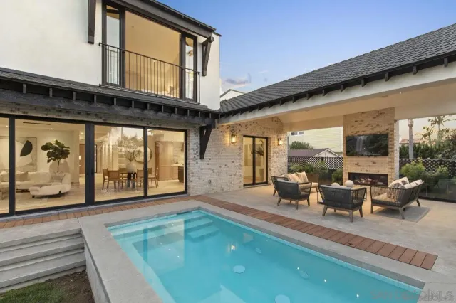 a view of a living room and balcony with furniture