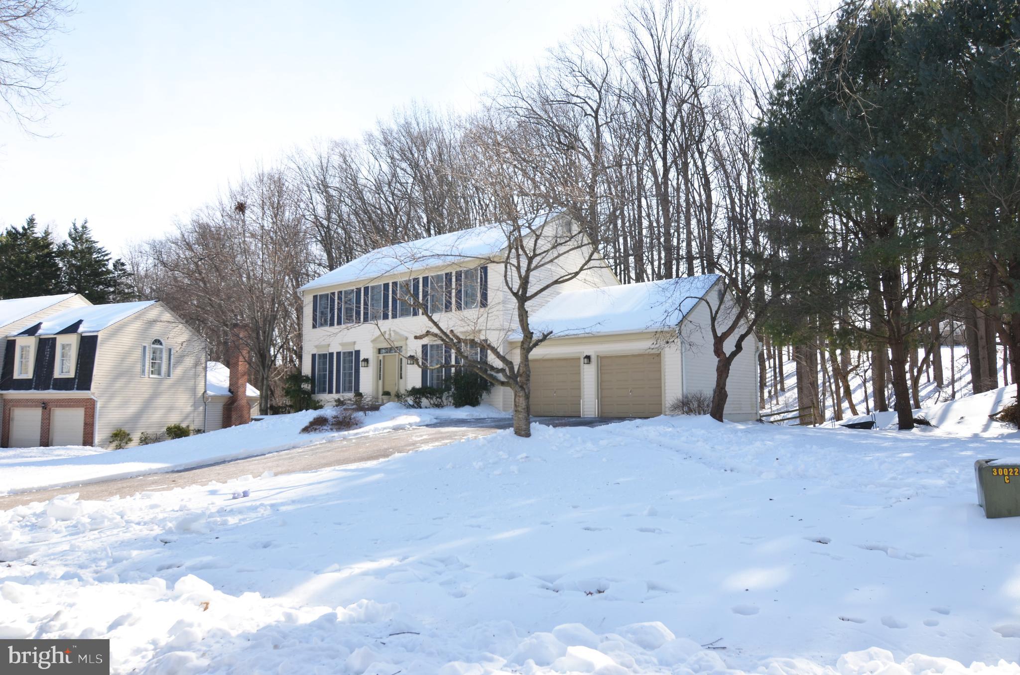 a view of a house with a yard and covered with snow