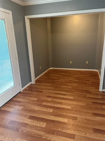 a view of room with window and hardwood floor