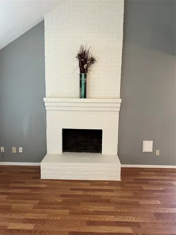 a living room with a fireplace and a fireplace