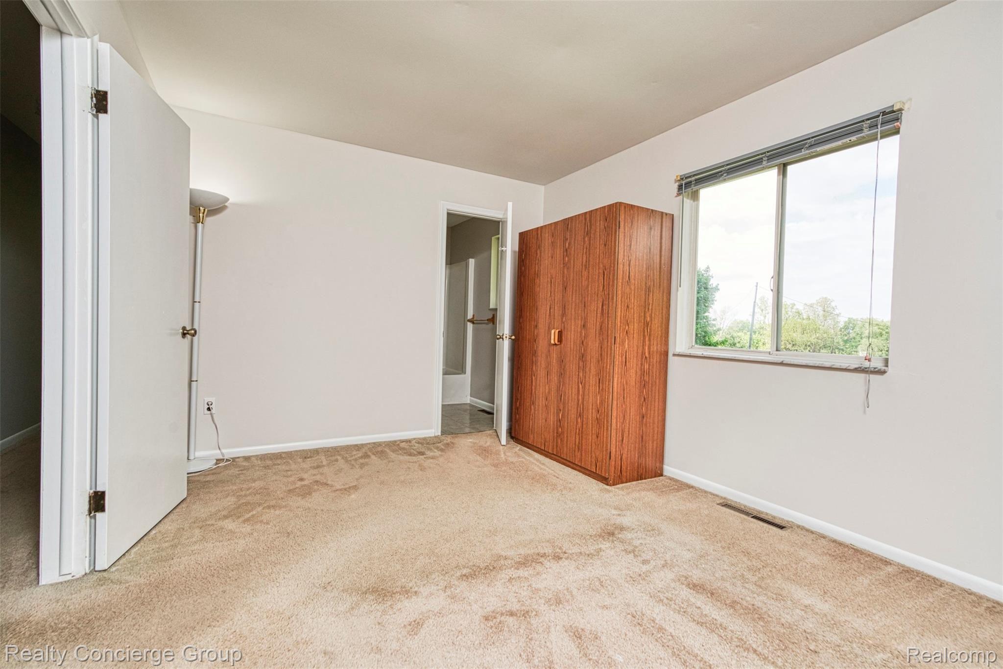 6505 Byron Road Howell, MI 48855 - Photo 10 of 20 Master bedroom features large windows for beautiful views outside.