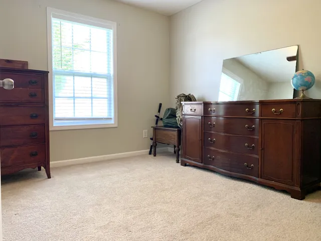 a room with a dresser and a window