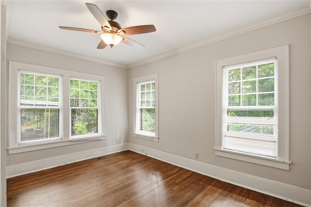 1424 Emory Road Northeast Atlanta, GA 30306 - Photo 21 of 36 a view of an empty room with wooden floor and a window