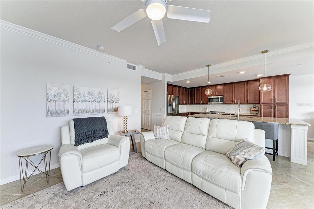 17006 Vardon Terrace, Unit 206 Lakewood Ranch, FL 34211 - Photo 12 of 79 a living room with furniture and a fireplace