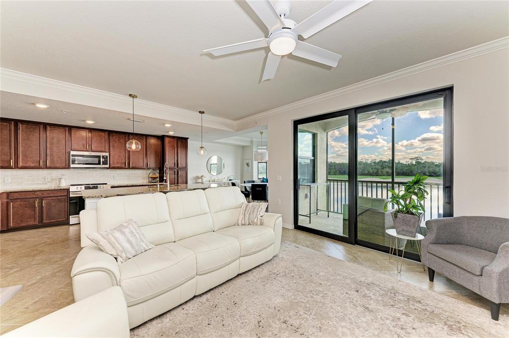 17006 Vardon Terrace, Unit 206 Lakewood Ranch, FL 34211 - Photo 13 of 79 a living room with furniture and a large window with kitchen view