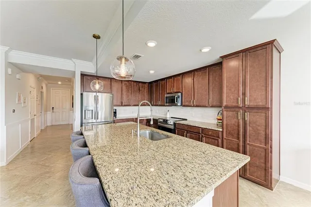 a dining room with furniture a chandelier and wooden floor