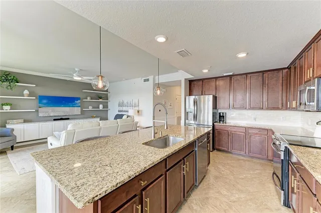a dining room with furniture a chandelier and wooden floor