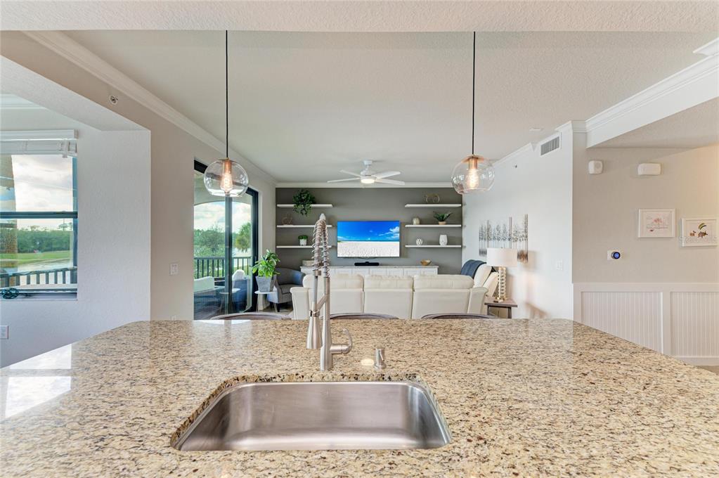 17006 Vardon Terrace, Unit 206 Lakewood Ranch, FL 34211 - Photo 19 of 79 a kitchen with kitchen island a sink appliances and a counter space