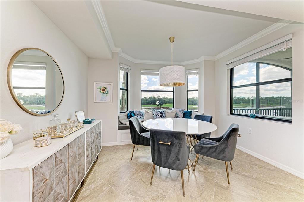 17006 Vardon Terrace, Unit 206 Lakewood Ranch, FL 34211 - Photo 20 of 79 a dining room with furniture a chandelier and wooden floor