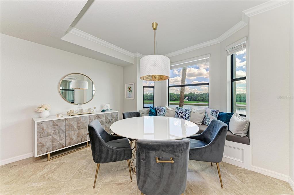 17006 Vardon Terrace, Unit 206 Lakewood Ranch, FL 34211 - Photo 21 of 79 a dining room with furniture a chandelier and wooden floor