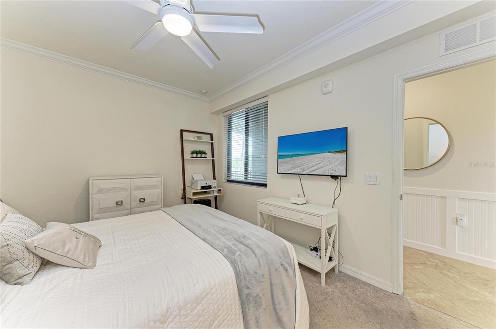 17006 Vardon Terrace, Unit 206 Lakewood Ranch, FL 34211 - Photo 26 of 79 a bedroom with a bed and a chandelier