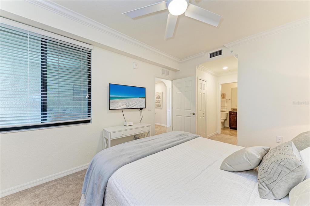 17006 Vardon Terrace, Unit 206 Lakewood Ranch, FL 34211 - Photo 27 of 79 a bedroom with a bed and a chandelier