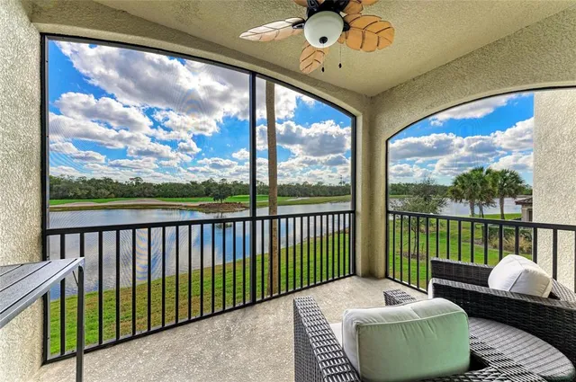 a kitchen with a stove a counter top space and living room view