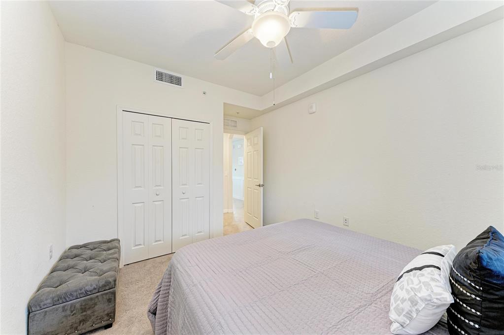 17006 Vardon Terrace, Unit 206 Lakewood Ranch, FL 34211 - Photo 31 of 79 a bedroom with a bed and a chandelier