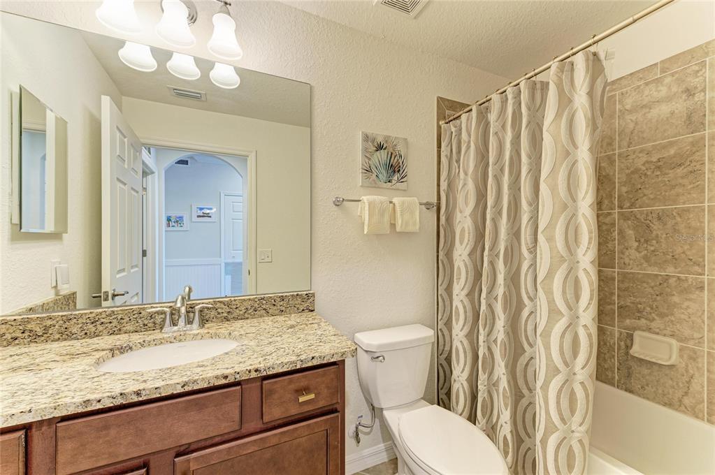 17006 Vardon Terrace, Unit 206 Lakewood Ranch, FL 34211 - Photo 32 of 79 a bathroom with a granite countertop sink mirror vanity and toilet