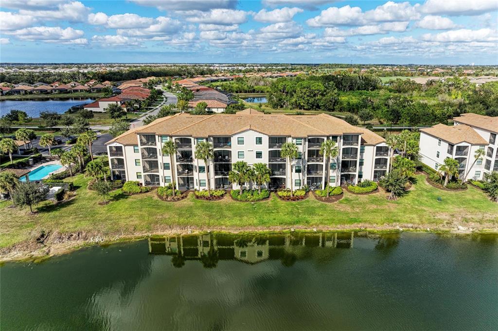17006 Vardon Terrace, Unit 206 Lakewood Ranch, FL 34211 - Photo 40 of 79 a view of a lake with a house in the background