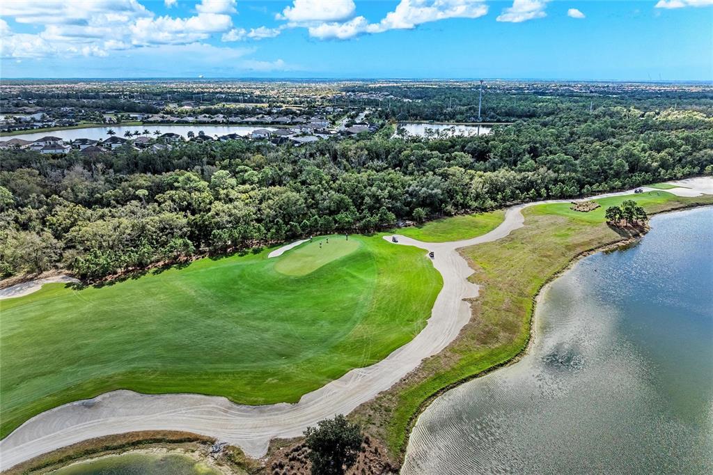 17006 Vardon Terrace, Unit 206 Lakewood Ranch, FL 34211 - Photo 43 of 79 an aerial view of a house with a yard and lake view