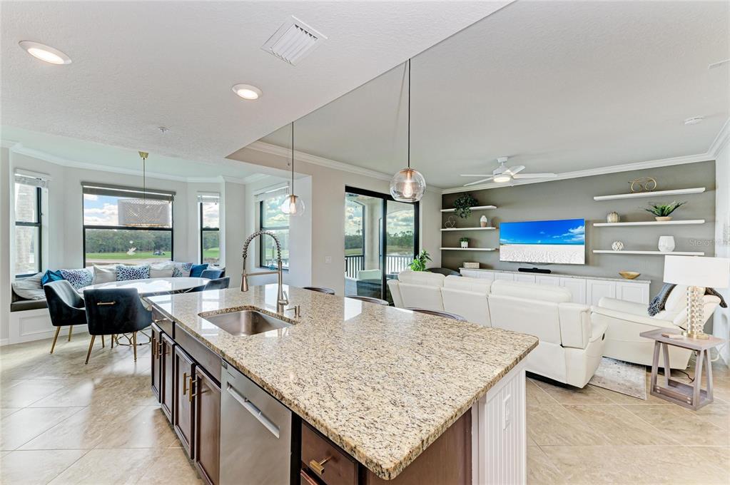 17006 Vardon Terrace, Unit 206 Lakewood Ranch, FL 34211 - Photo 6 of 79 a kitchen with a stove a counter top space and living room view