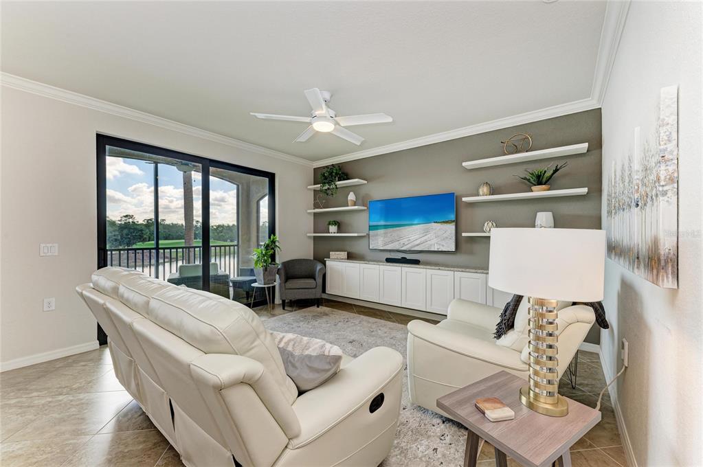 17006 Vardon Terrace, Unit 206 Lakewood Ranch, FL 34211 - Photo 10 of 79 a living room with furniture and a large window with kitchen view