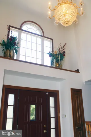 a front view of a house with a large window and potted plants
