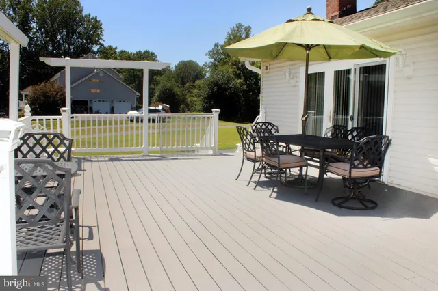 a view of a chair and tables in the patio