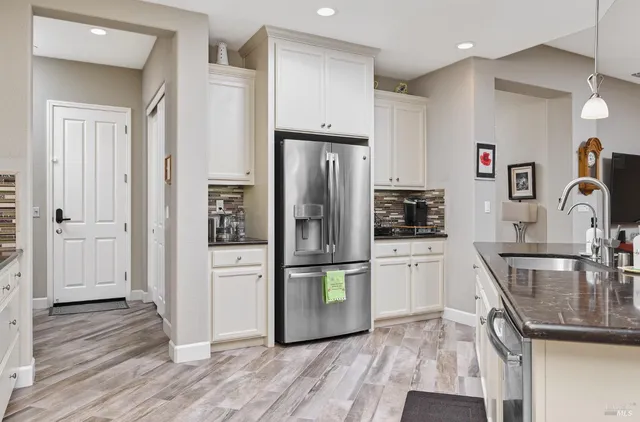 a kitchen with stainless steel appliances granite countertop a refrigerator microwave and stove