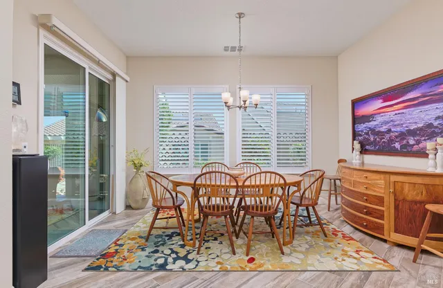 a view of a dining room with furniture wooden floor and a chandelier