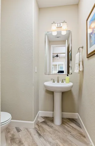 a bathroom with a sink toilet and mirror