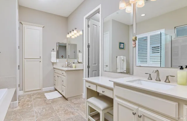 a spacious bathroom with a sink double vanity and a mirror