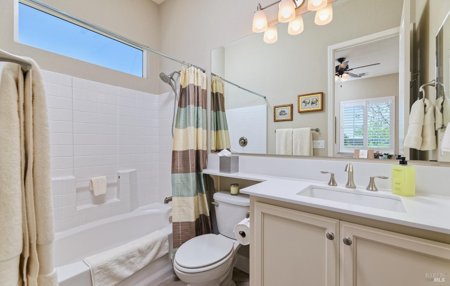 278 Longspur Drive Rio Vista, CA 94571 - Photo 28 of 29 a bathroom with a sink a toilet a mirror a bathtub and shower