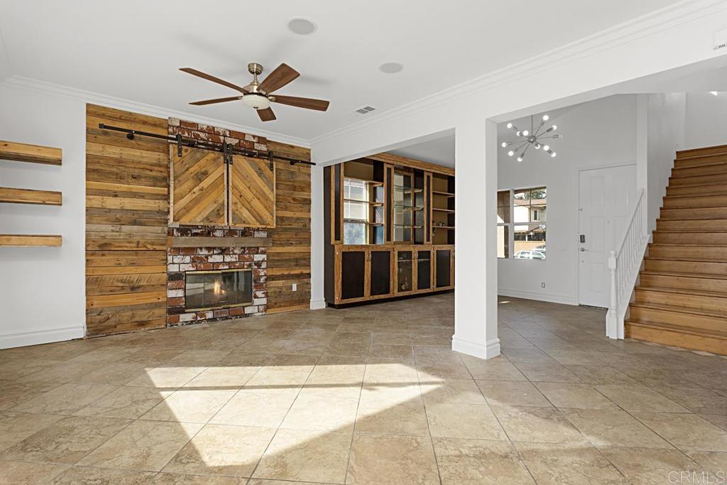 27611 Marian Road Temecula, CA 92591 - Photo 3 of 13 a view of an empty room with wooden floor and a ceiling fan