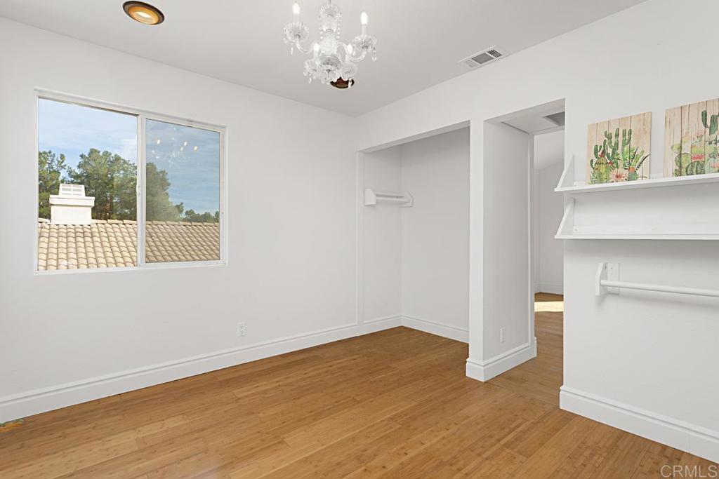 27611 Marian Road Temecula, CA 92591 - Photo 9 of 13 wooden floor in an empty room with a window