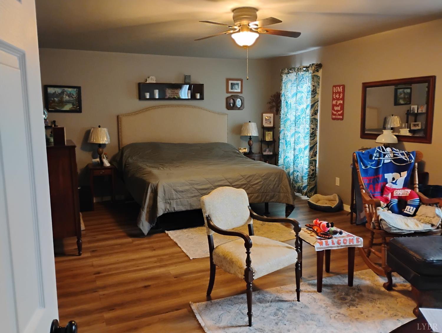 4183 Tye River Road Amherst, VA 24521 - Photo 17 of 62 a bedroom with furniture and a wooden floor