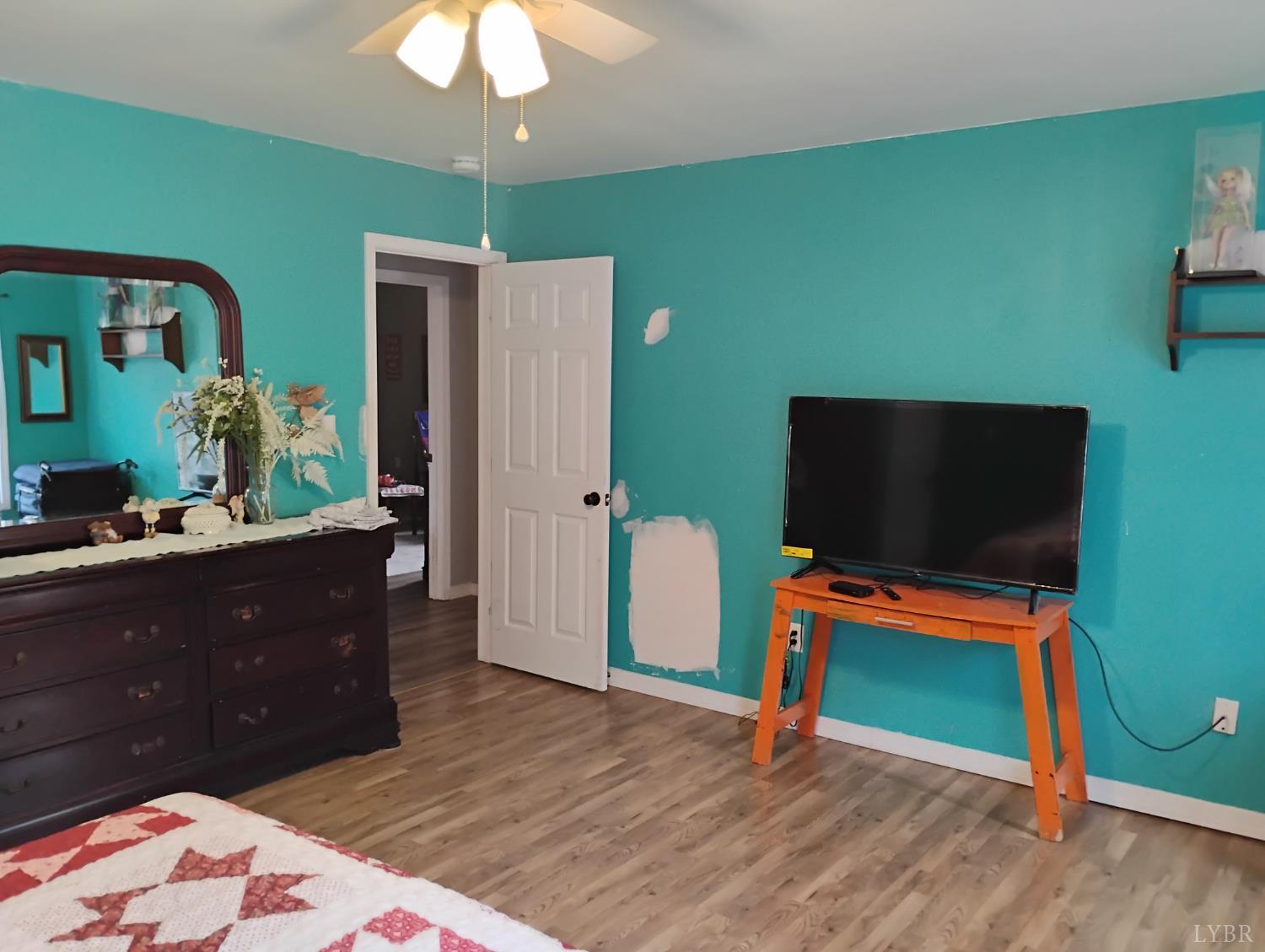 4183 Tye River Road Amherst, VA 24521 - Photo 29 of 62 a bedroom with a bed and a flat screen tv