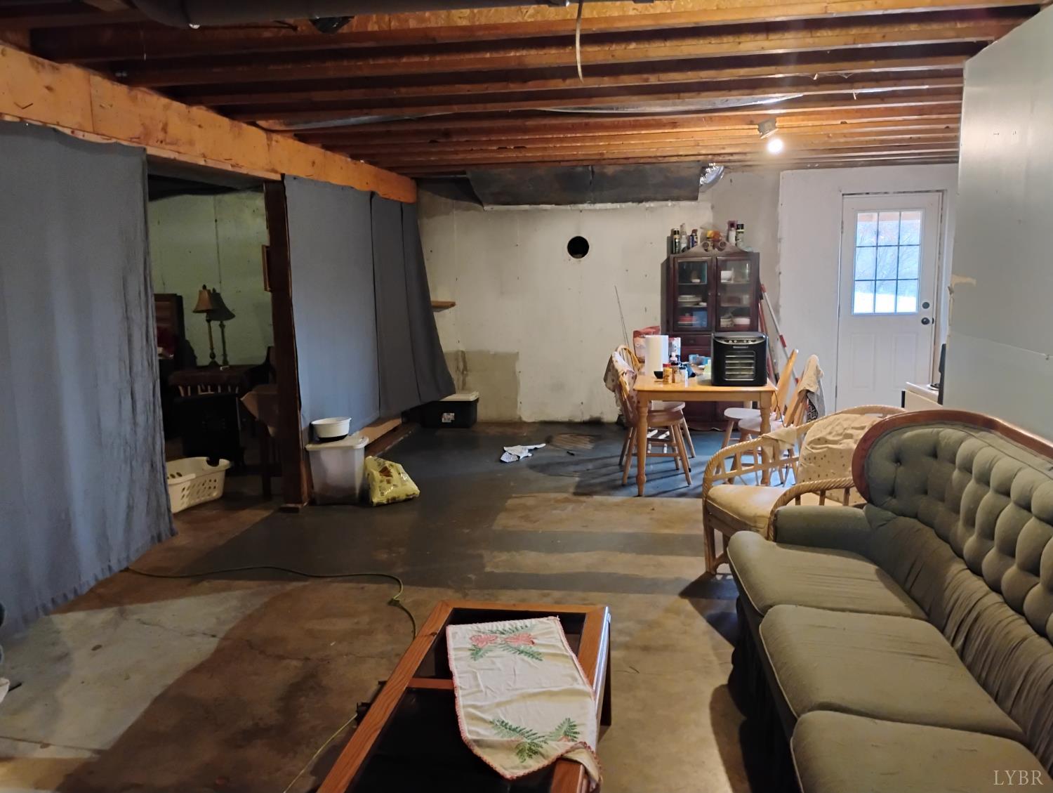 4183 Tye River Road Amherst, VA 24521 - Photo 37 of 62 a living room with furniture and a chandelier