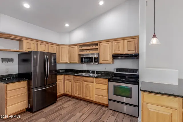 a kitchen with stainless steel appliances a stove sink and refrigerator