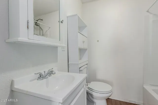 a bathroom with a sink toilet and a mirror