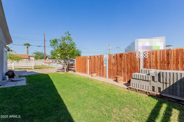 a view of backyard with a garden and deck
