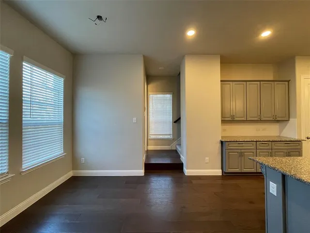 a view of a refrigerator in kitchen and wooden floor