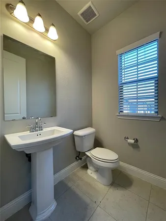 a bathroom with a sink a toilet and mirror