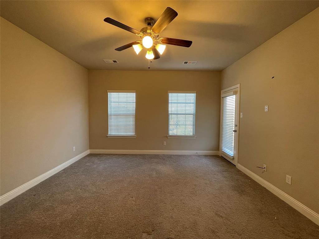 2401 Springhill Avenue Flower Mound, TX 75028 - Photo 19 of 27 an empty room with windows and a ceiling fan