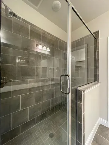 a bathroom with a shower and a sink