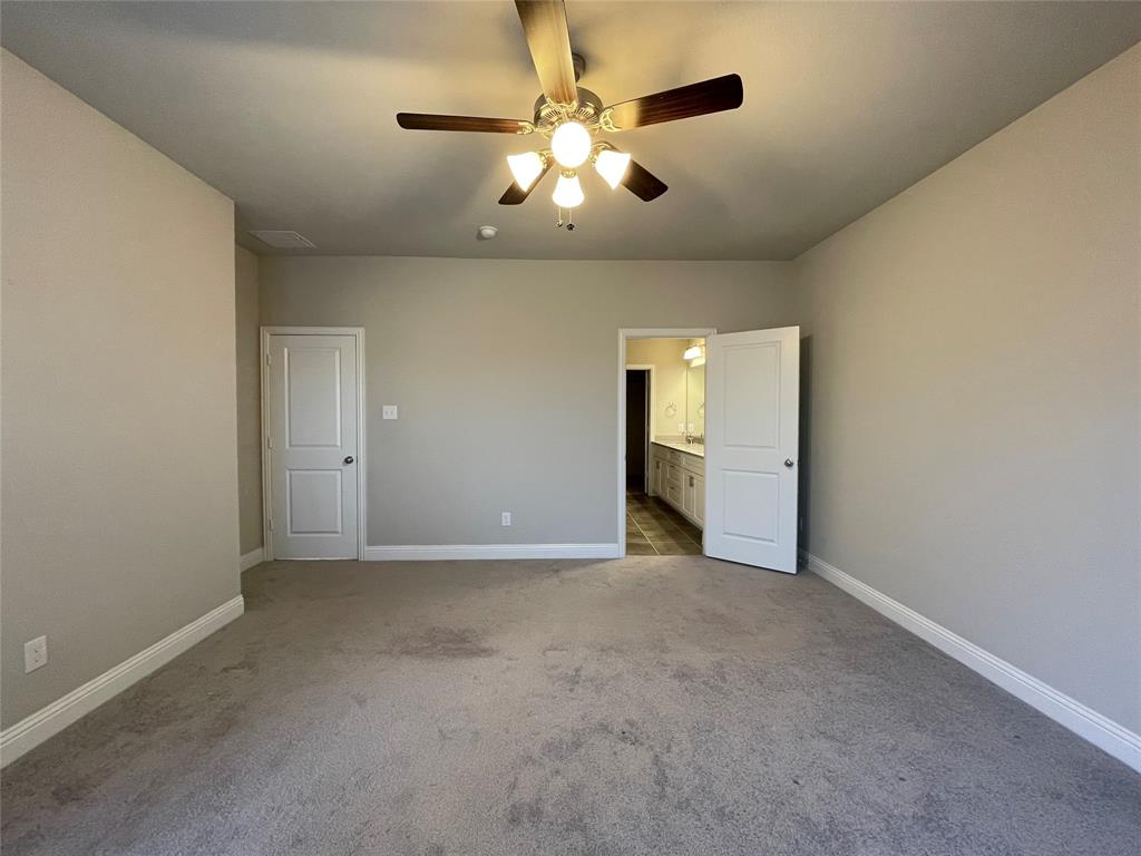 2401 Springhill Avenue Flower Mound, TX 75028 - Photo 24 of 27 an empty room with chandelier fan and windows