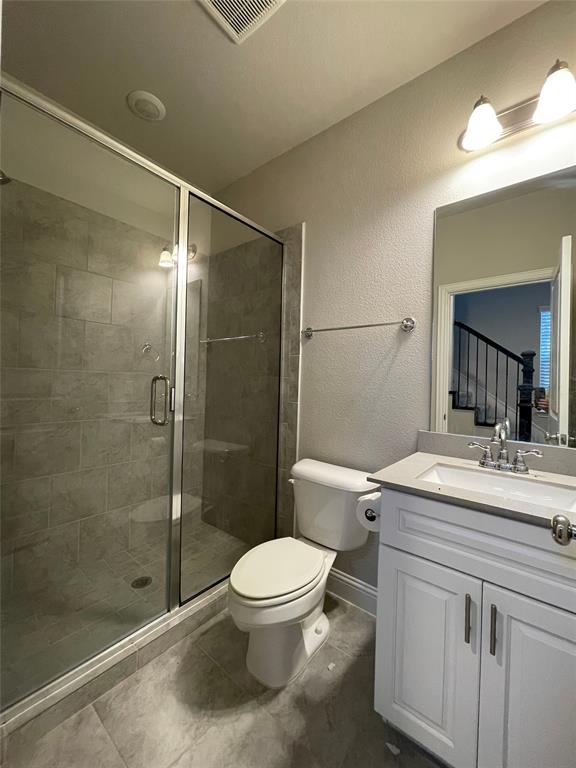 2401 Springhill Avenue Flower Mound, TX 75028 - Photo 27 of 27 a bathroom with a sink a toilet and shower