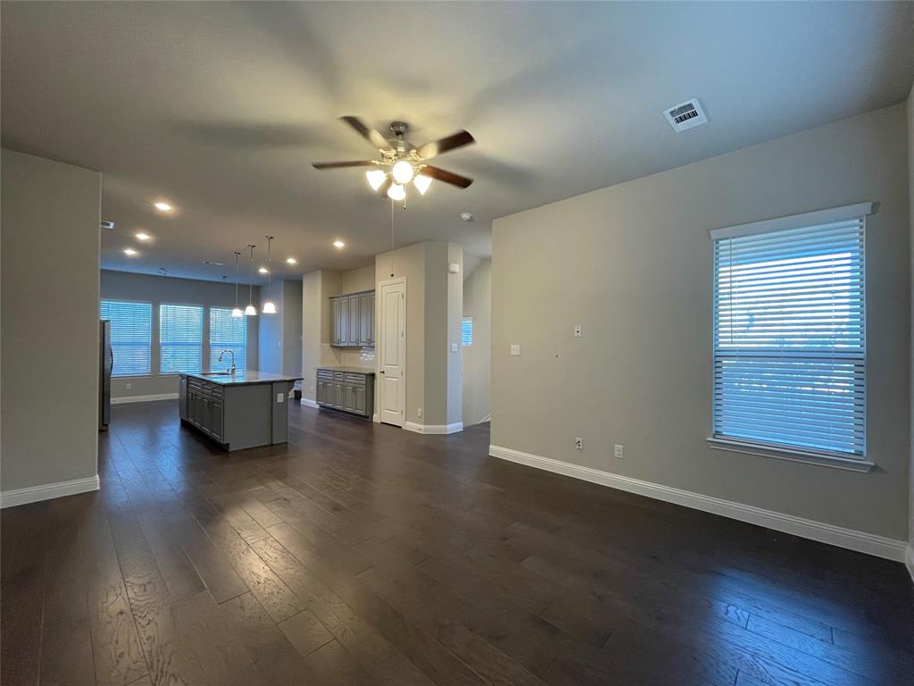 2401 Springhill Avenue Flower Mound, TX 75028 - Photo 3 of 27 a view of an empty room with wooden floor and a window