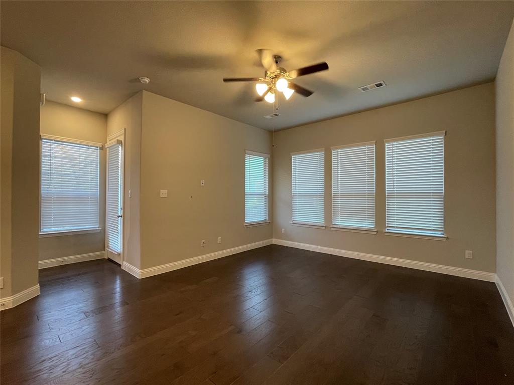 2401 Springhill Avenue Flower Mound, TX 75028 - Photo 5 of 27 a view of an empty room with wooden floor and a window