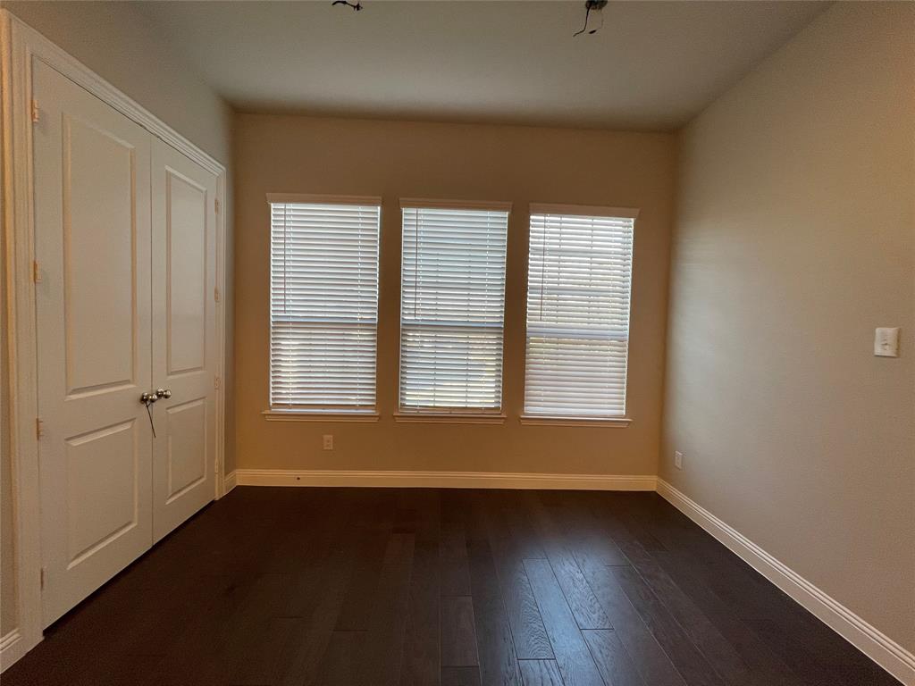 2401 Springhill Avenue Flower Mound, TX 75028 - Photo 9 of 27 an empty room with wooden floor and windows