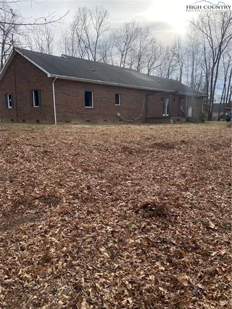 a backyard of a house with large trees