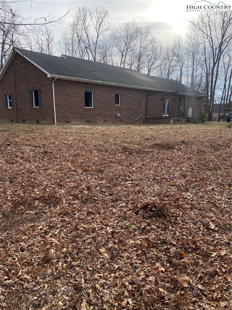 48 Saddle Mountain Church Road Ennice, NC 28623 - Photo 16 of 24 a backyard of a house with large trees